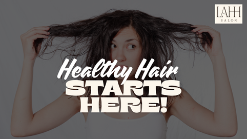 Woman holding up her frizzy, damaged hair