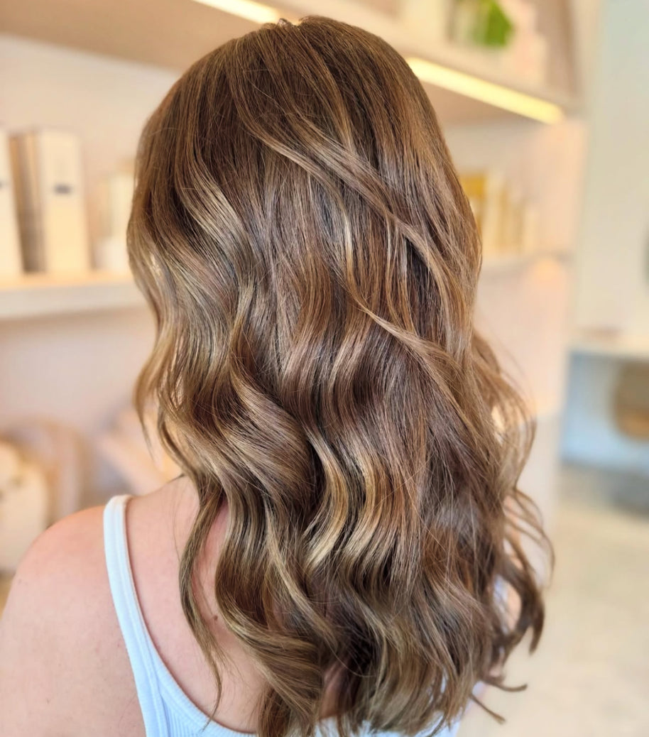 Close-up of wavy brown hair with a blurred background