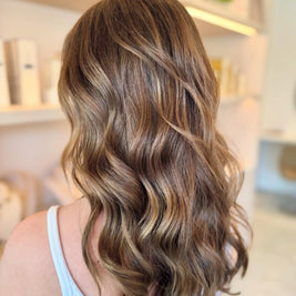 Close-up of wavy brown hair with a blurred background